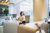 Preview: prosperous Asian woman in smart casual outfit enjoying day in modern coworking space