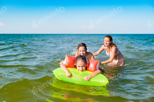 Preview: Happy mother and two small positive daughters