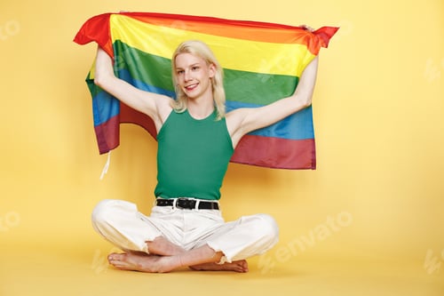 Preview: Studio photo of a fashionable man with make up isolated on yellow background