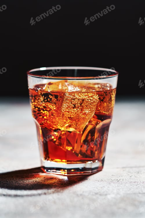 Preview: Glass with cola with ice in bright sunlight
