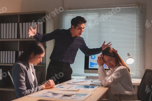 Preview: Asian businesspeople working late having an argument in the office