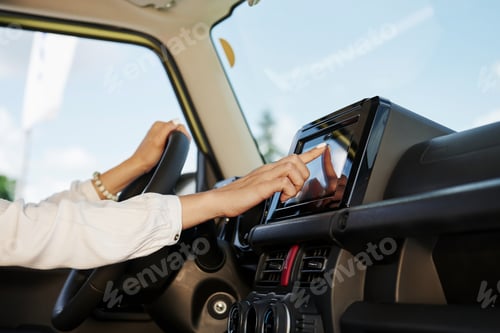 Preview: Control panel. Particle view of woman that drives modern new car in the city