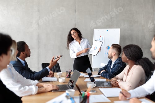 Preview: Latin Businesswoman Making Business Presentation For Colleagues In Modern Office