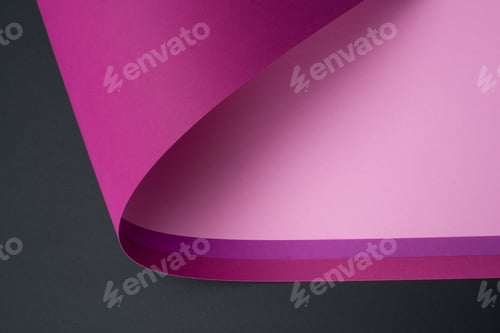 Preview: roll of purple and pink paper isolated on black