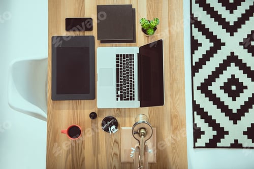 Preview: top view of laptop with graphics tablet and smartphone on wooden tabletop at office