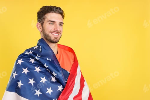 Preview: Proud caucasian man wrapping with a north america national flag