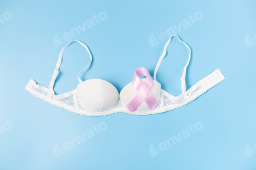 Preview: Pink ribbon and bra on a blue background.