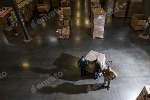 Preview: A group of three warehouse workers standing in the center of a distirbution warehouse.