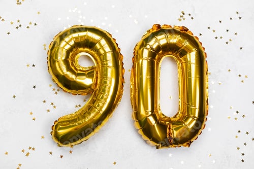 Preview: Golden balloons display the number 90 among sparkling confetti decorations