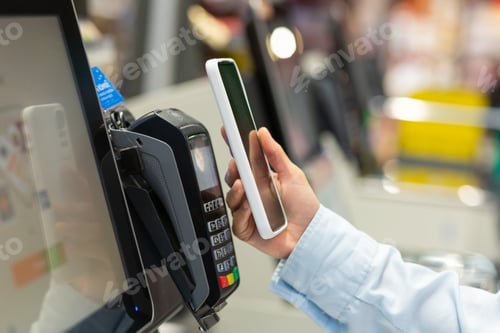 Preview: Closeup Woman Counter Buy electronic payment supermarket smartphone Female hand with a mobile phone
