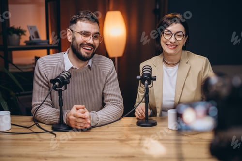 Preview: Two happy podcasters, a man and a woman, are recording a new podcast episode in professional studio