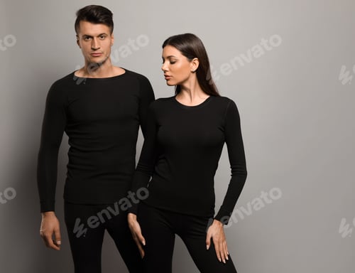 Preview: Couple wearing thermal underwear on grey background. Space for text