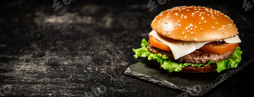 Preview: A burger on a stone board on a table.