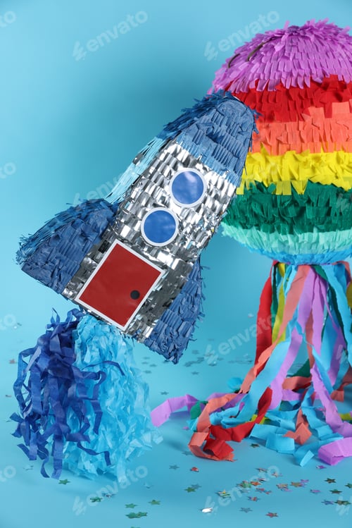 Preview: Bright colorful pinatas and confetti on light blue background