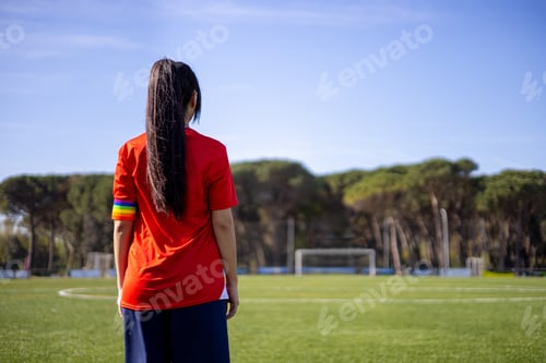 Preview: Female soccer player with captain armband with LGBT pride flag