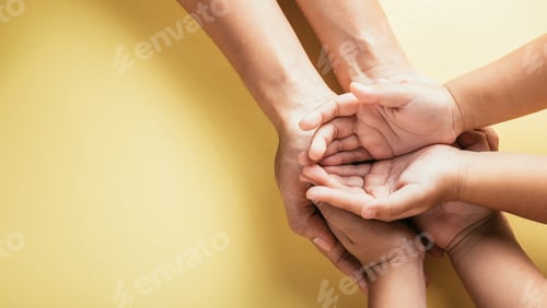 Preview: A studio shot with a top view angle showcasing family hands stacked against an isolated background.