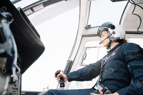 Preview: Attractive woman pilot sitting in the helicopter