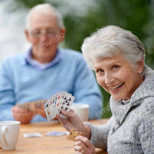 Preview: Helping the time pass with card games. Two seniors playing cards together.