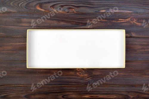 Preview: Open Cardboard white box on a dark table, wooden background. top view
