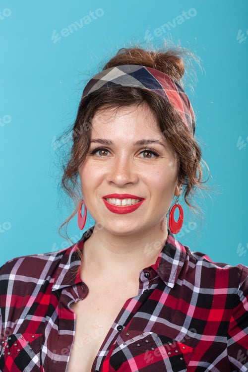 Preview: pin-up, model and beauty concept - young woman in pin-up style over the blue background