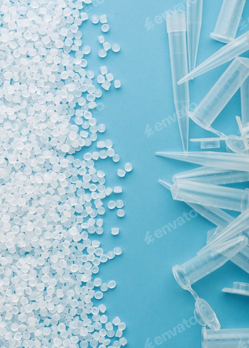 Preview: Plastic pellets contrast sterile pipette tips on blue background