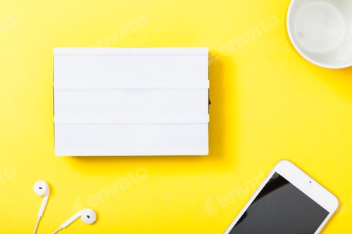 Preview: Empty light box with copy space on yellow background with technology devices