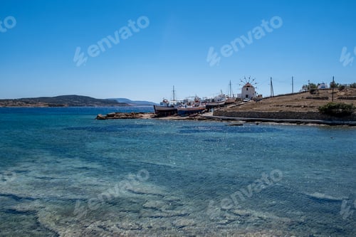 Preview: Greece. Koufonisi island, Cyclades. Windmill, shipyard for wooden fishing boat, sea, blue sky.