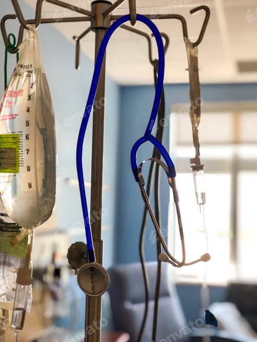 Preview: Bag of IV fluid hanging with stethoscope in hospital room