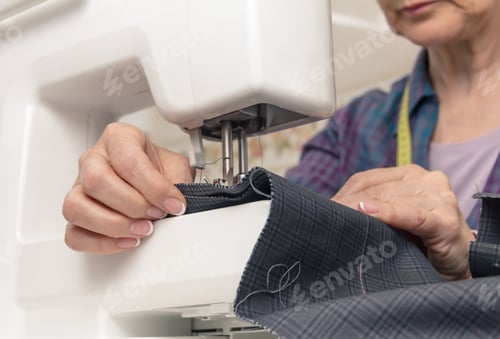 Preview: Seamstress hands working on a sewing machine
