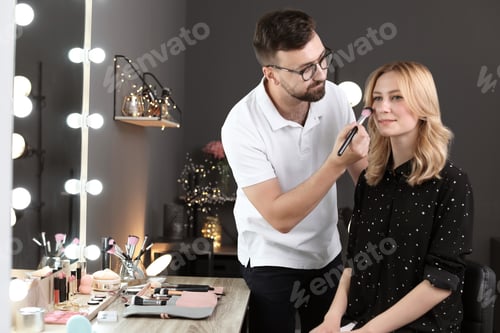 Preview: Professional makeup artist working with client in dressing room