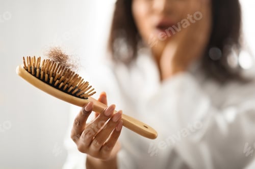 Preview: Shocked Black Lady Holding Brush Full Of Fallen Hair