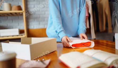 Preview: Close-up of preparing a parcel on the table. Woman online store, small business owner, entrepreneur.