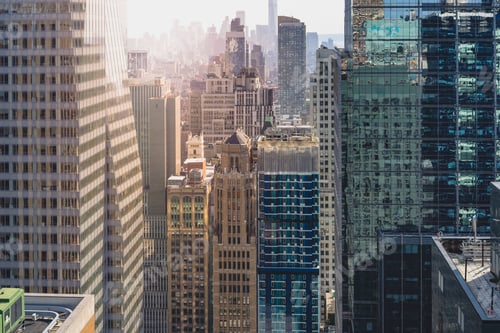 Preview: Drone view of modern skyscrapers captured with soft sunset lights in New York City.