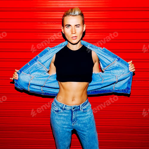 Preview: Stylish model in jeans outfit on a red background. Street style