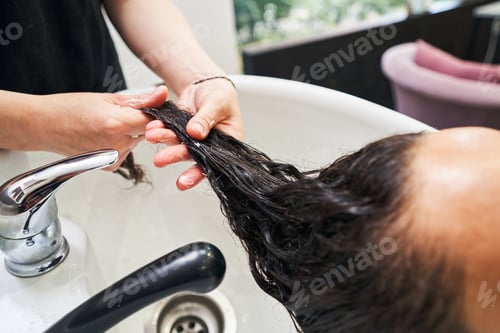 Preview: Close up of cosmetologist doing hair caring mask