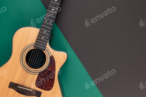 Preview: Acoustic guitar on a colored background, flat lay.