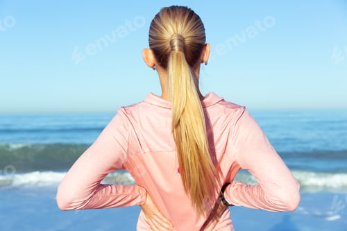 Preview: Woman with Lower Back Pain at the Beach