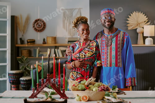 Preview: Portrait of Middle Aged Black Couple Celebrating Kwanzaa with Kinara Candle