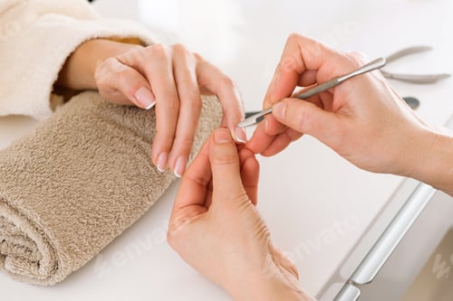 Preview: Manicurist tending nails of female client