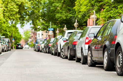 Preview: Rows of cars parked on the roadside in residential district