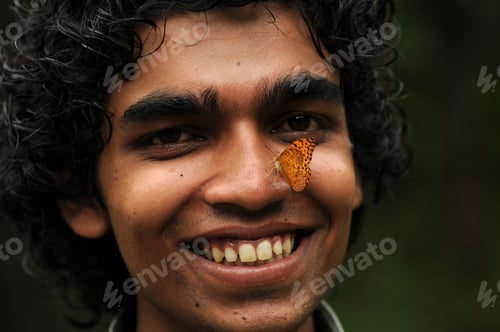 Preview: Butterfly sitting on a young man’s face, Symbiosis of man and nature.