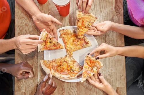 Preview: View from above of tasty pizza lying on plate in cafe