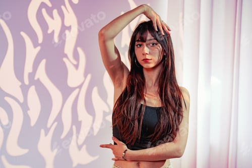 Preview: Model poses elegantly in a stylish studio with creative lighting and artistic backdrop