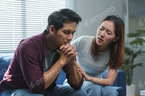 Preview: Young woman comforting sad man at home