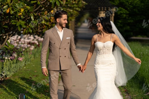 Preview: The bride and groom hold their hands