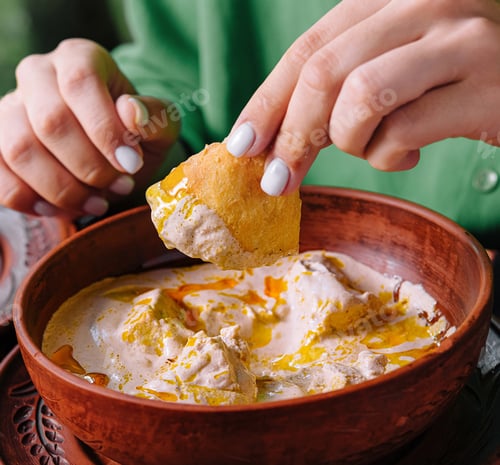 Preview: Enjoying traditional soup dish with bread