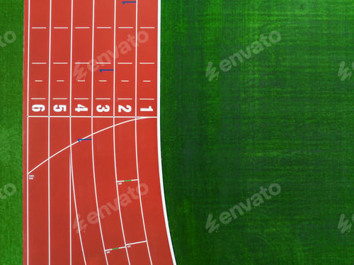 Preview: Aerial View of a Red Running Track Next to a Green Grass Field During Daylight