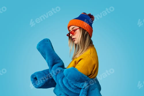 Preview: Young woman examining sleeves of fur coat