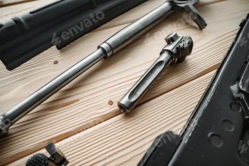 Preview: Shotgun parts on the wooden table background.