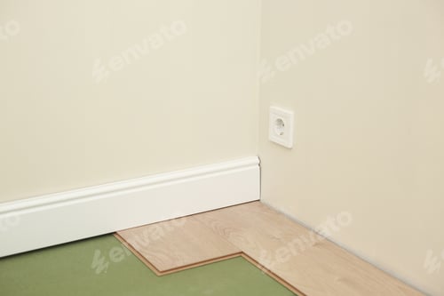 Preview: Installing wooden laminate or parquet floor in room over green base. assembling panels quickly